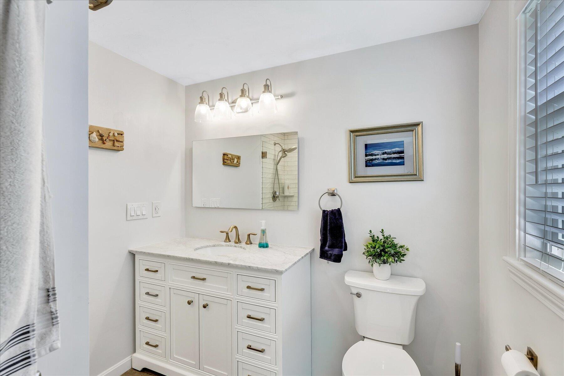 12 Drew Lane Mashpee, MA 02649 - Photo 31 of 49 a bathroom with a toilet sink and mirror