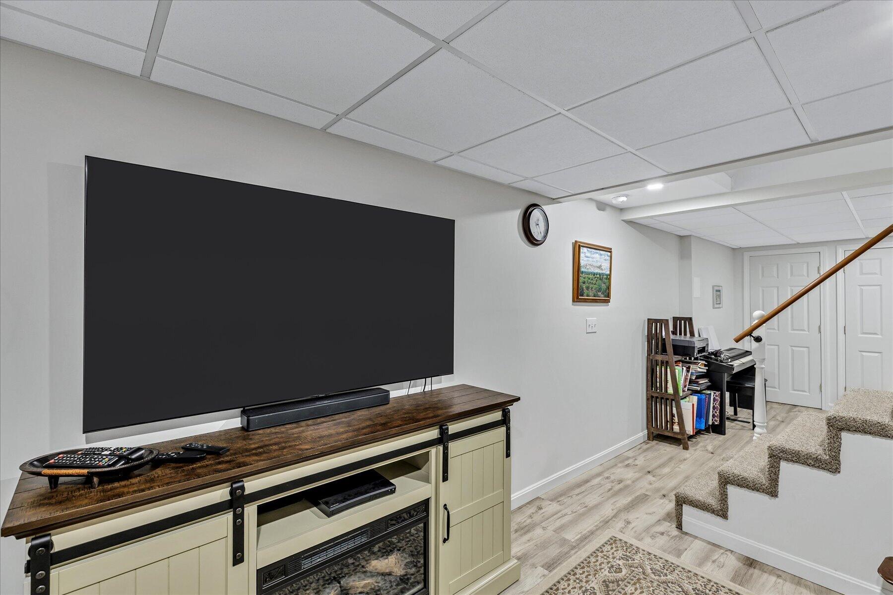 12 Drew Lane Mashpee, MA 02649 - Photo 39 of 49 a living room with furniture and a flat screen tv
