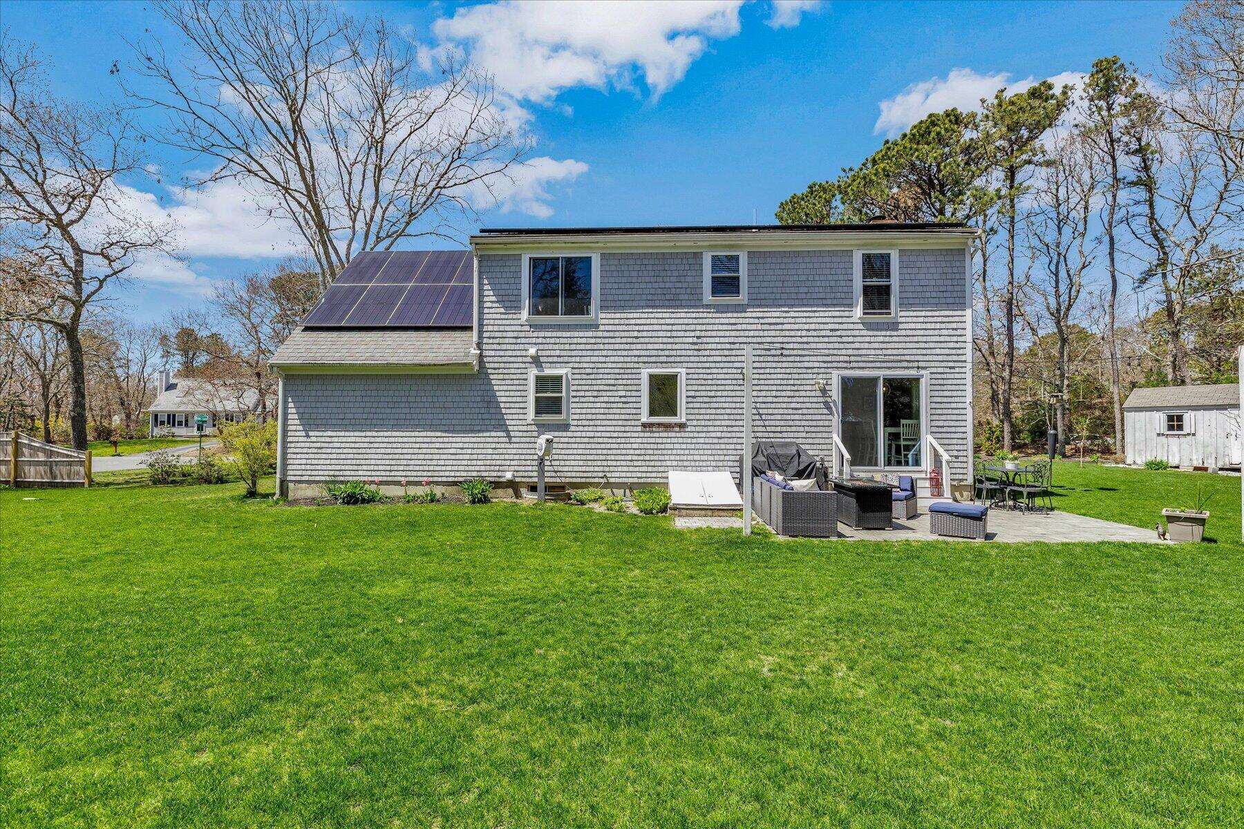 12 Drew Lane Mashpee, MA 02649 - Photo 42 of 49 a view of a house with backyard sitting area and garden