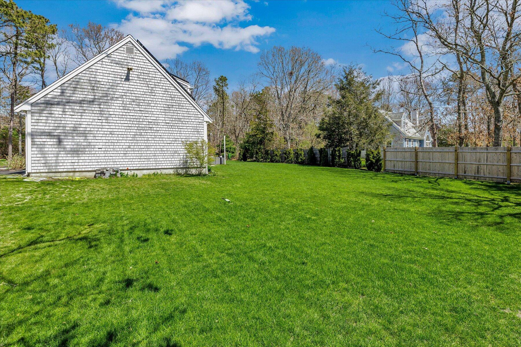 12 Drew Lane Mashpee, MA 02649 - Photo 45 of 49 a view of a backyard of the house