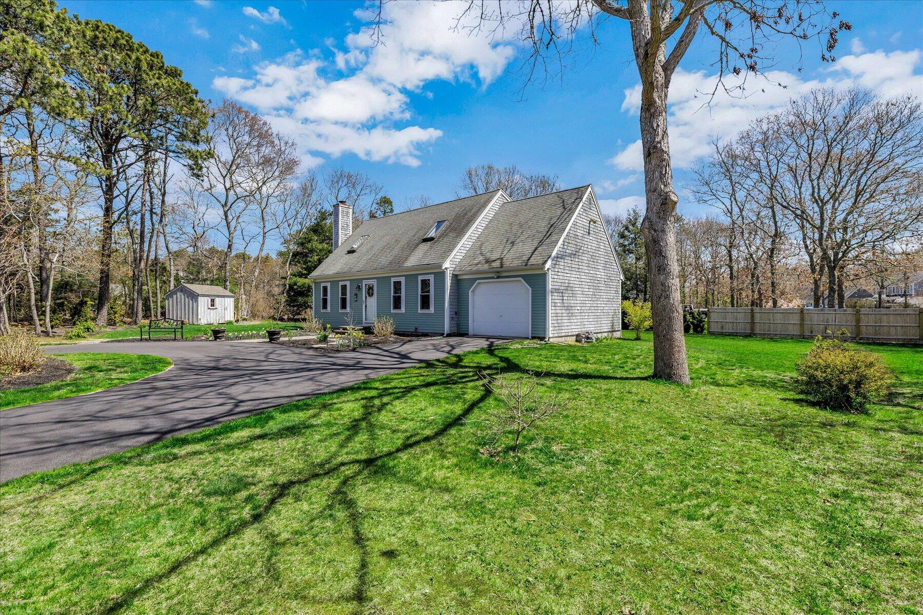 12 Drew Lane Mashpee, MA 02649 - Photo 46 of 49 a front view of a house with yard and green space