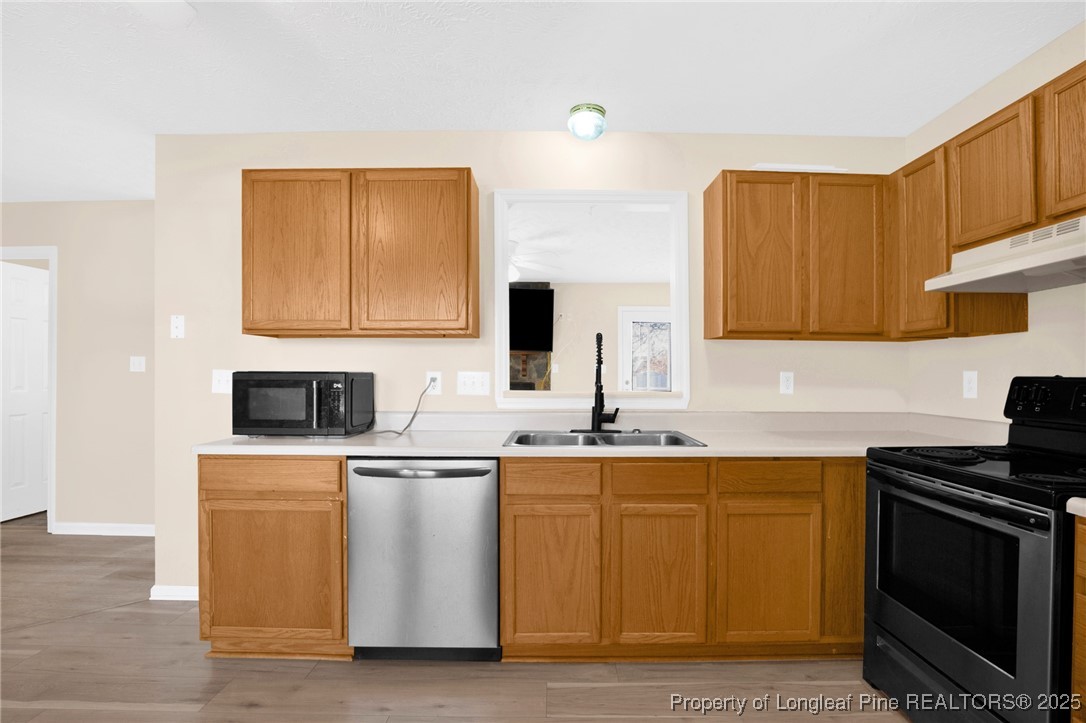 101 2 Hours Court Raeford, NC 28376 - Photo 11 of 30 a kitchen with stainless steel appliances a sink a stove and microwave