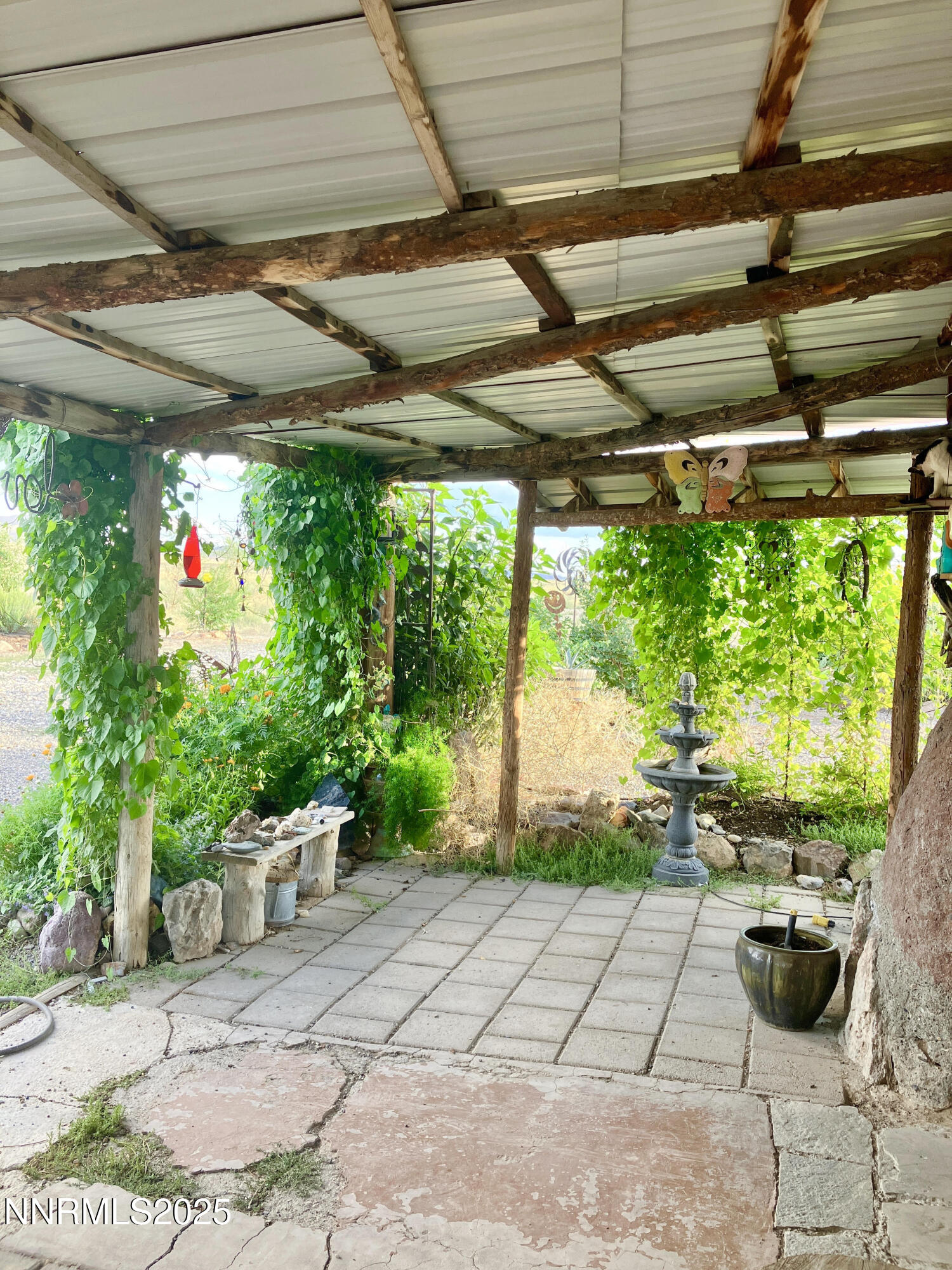 52 Horseshoe Circle Crescent Valley, NV 89821 - Photo 16 of 67 a backyard of a house with fountain and outdoor seating