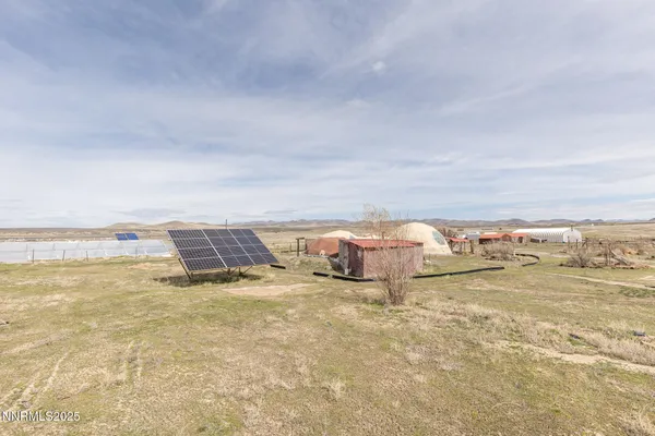 a view of a hallway to a livingroom and a window