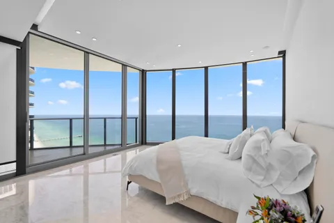 a large bedroom with a large bed and a large window