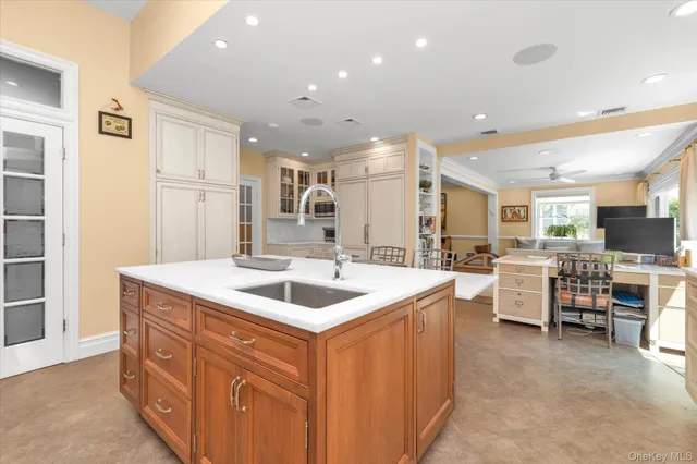 a kitchen with stainless steel appliances granite countertop a sink and a refrigerator