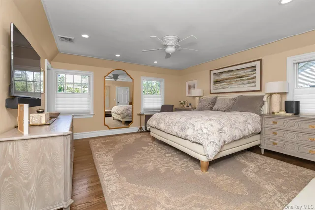 a bedroom with a large bed and a chandelier