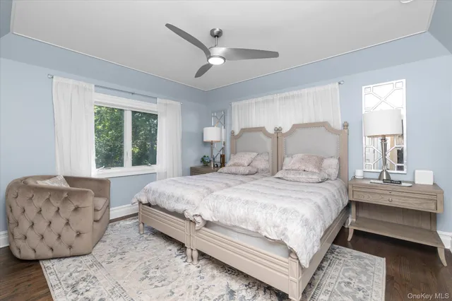 a bedroom with a large bed and windows