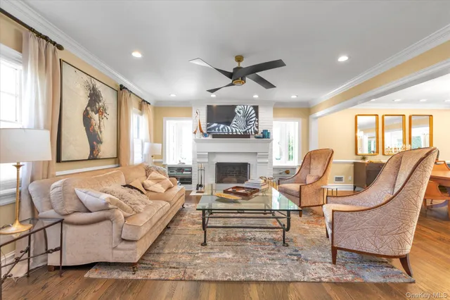 a living room with furniture a fireplace and a large window