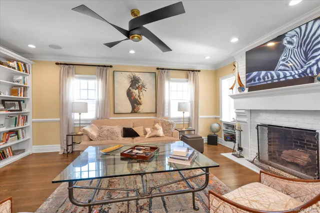 a living room with furniture a fireplace and a large window