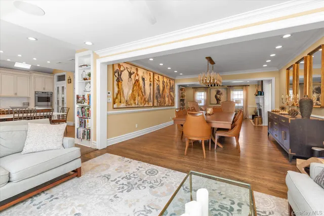 a living room with furniture and a dining table with kitchen view