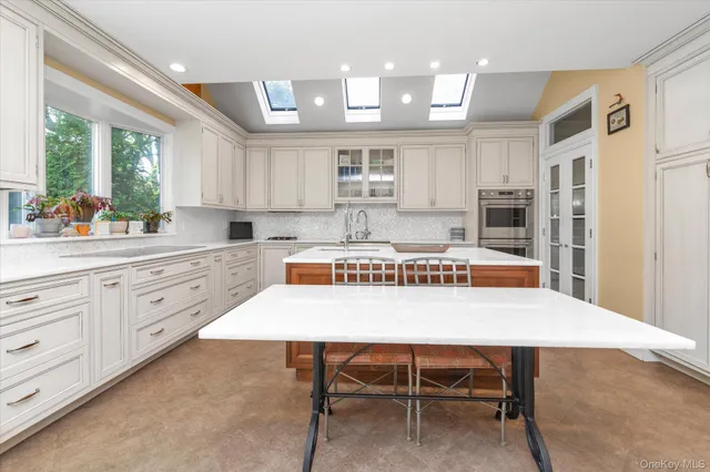 a large kitchen with a table and chairs