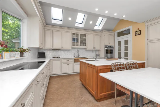 a kitchen with stainless steel appliances granite countertop a sink and cabinets
