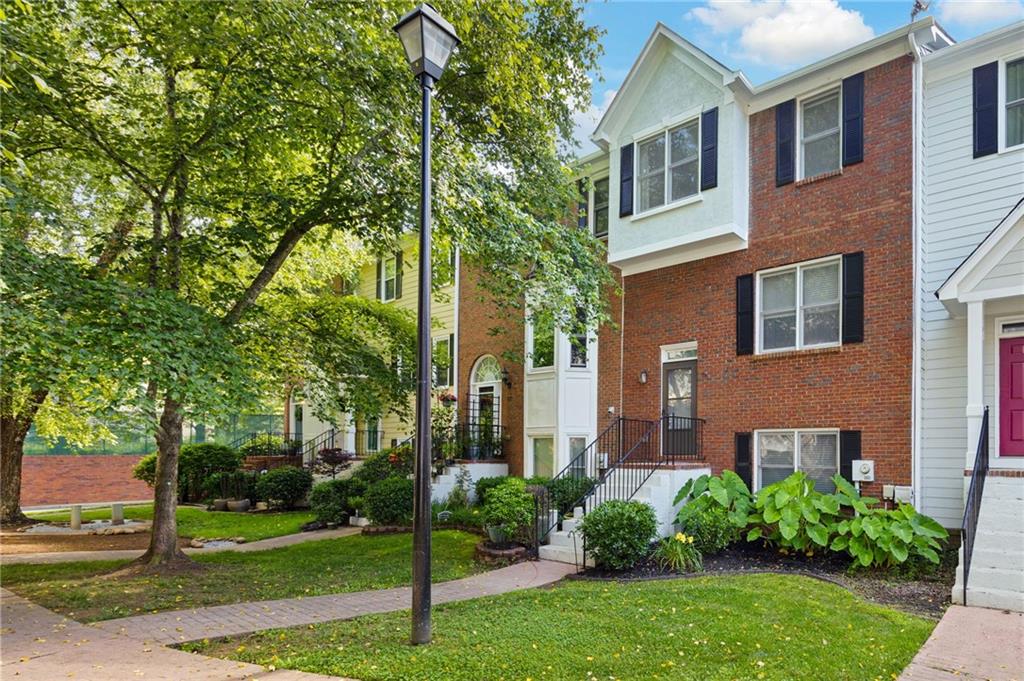 260 Manning Road Southwest, Unit 76 Marietta, GA 30064 - Photo 1 of 1 front view of a brick house with a yard