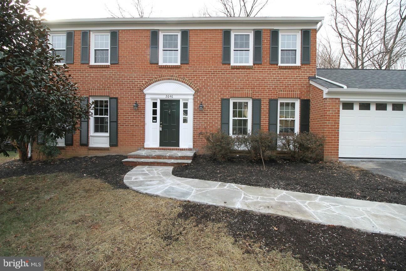 2646 Wild Cherry Place Reston, VA 20191 - Photo 2 of 26 a front view of a house with a yard