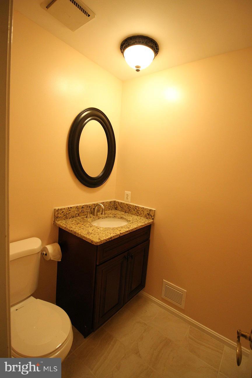 2646 Wild Cherry Place Reston, VA 20191 - Photo 11 of 26 a bathroom with a granite countertop sink and a mirror