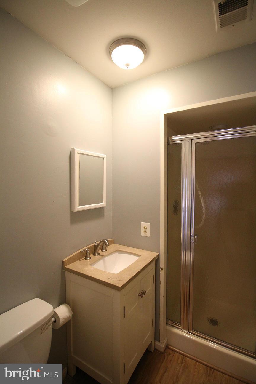2646 Wild Cherry Place Reston, VA 20191 - Photo 23 of 26 a bathroom with a sink mirror vanity and toilet