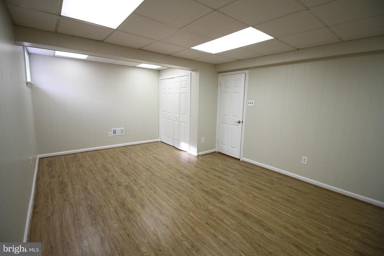 2646 Wild Cherry Place Reston, VA 20191 - Photo 24 of 26 a view of an empty room with wooden floor