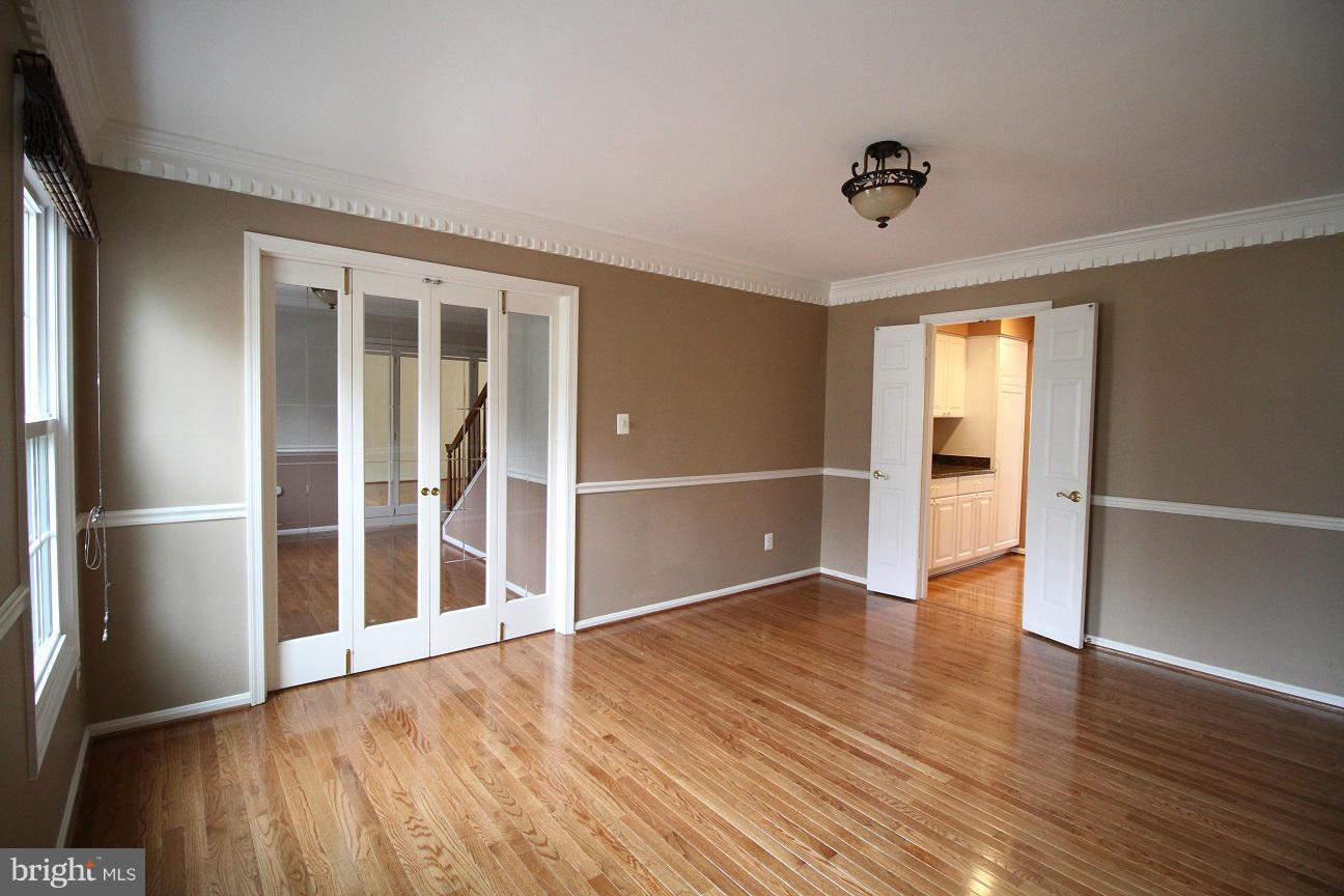 2646 Wild Cherry Place Reston, VA 20191 - Photo 4 of 26 an empty room with wooden floor and entrance