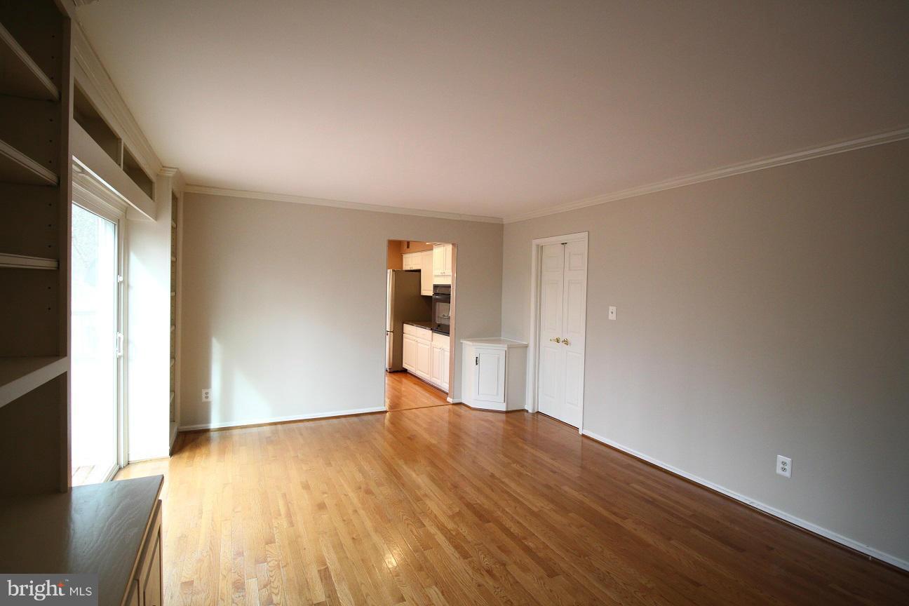 2646 Wild Cherry Place Reston, VA 20191 - Photo 9 of 26 a view of an empty room with wooden floor and a window