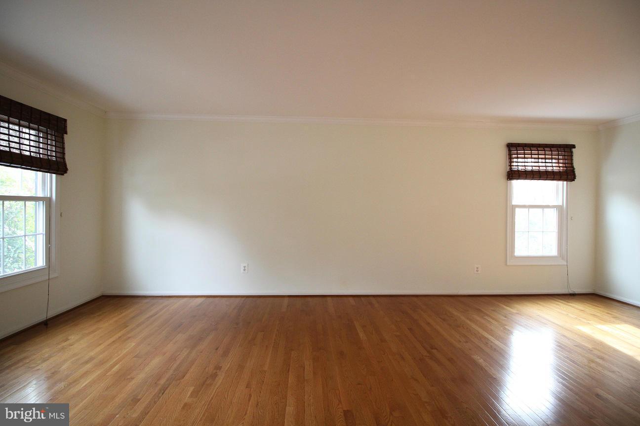 2646 Wild Cherry Place Reston, VA 20191 - Photo 10 of 26 an empty room with wooden floor and windows
