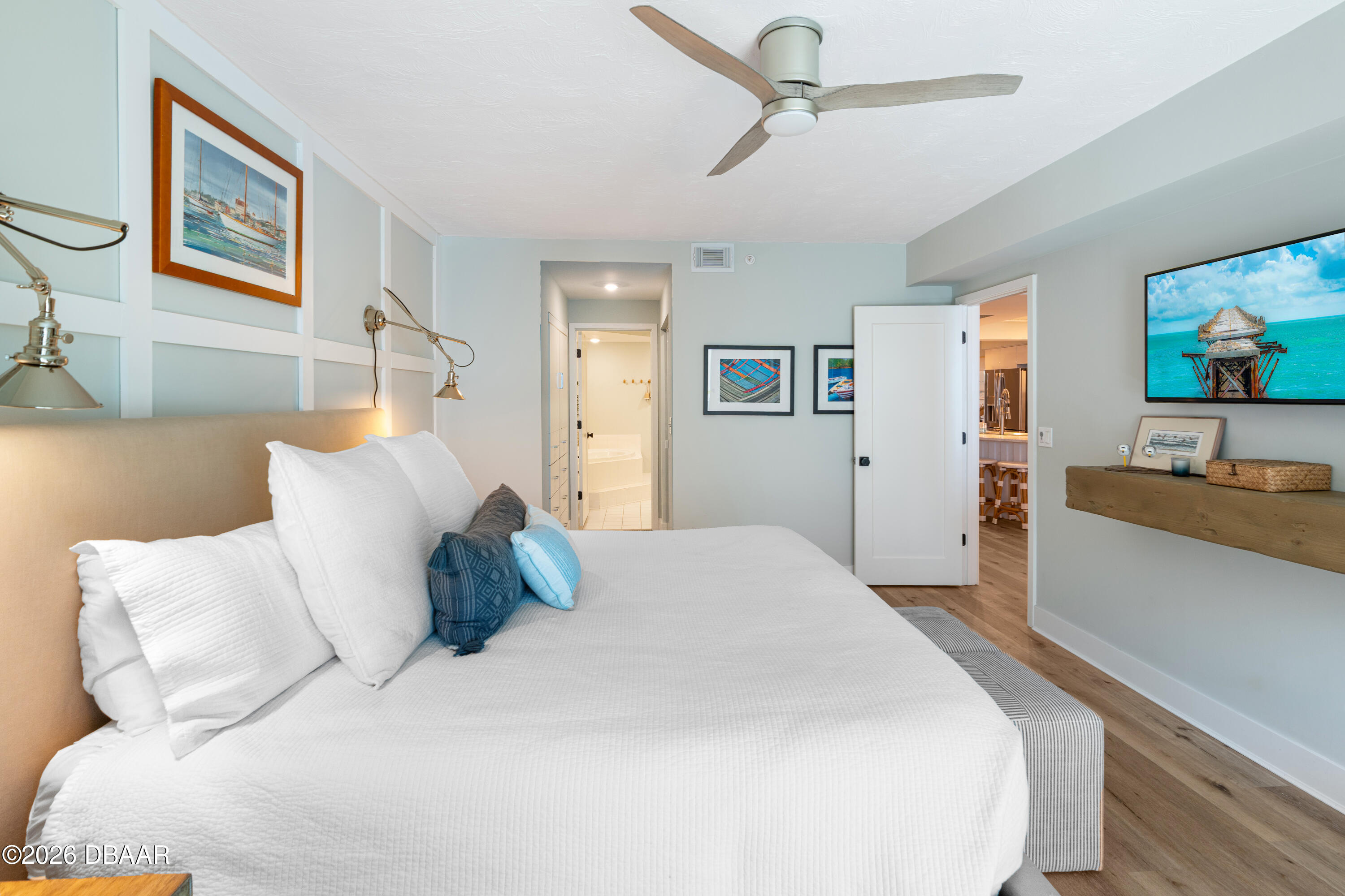 4565 South Atlantic Avenue, Unit 5410 Ponce Inlet, FL 32127 - Photo 35 of 67 a large bed sitting in a bedroom and painting on the wall