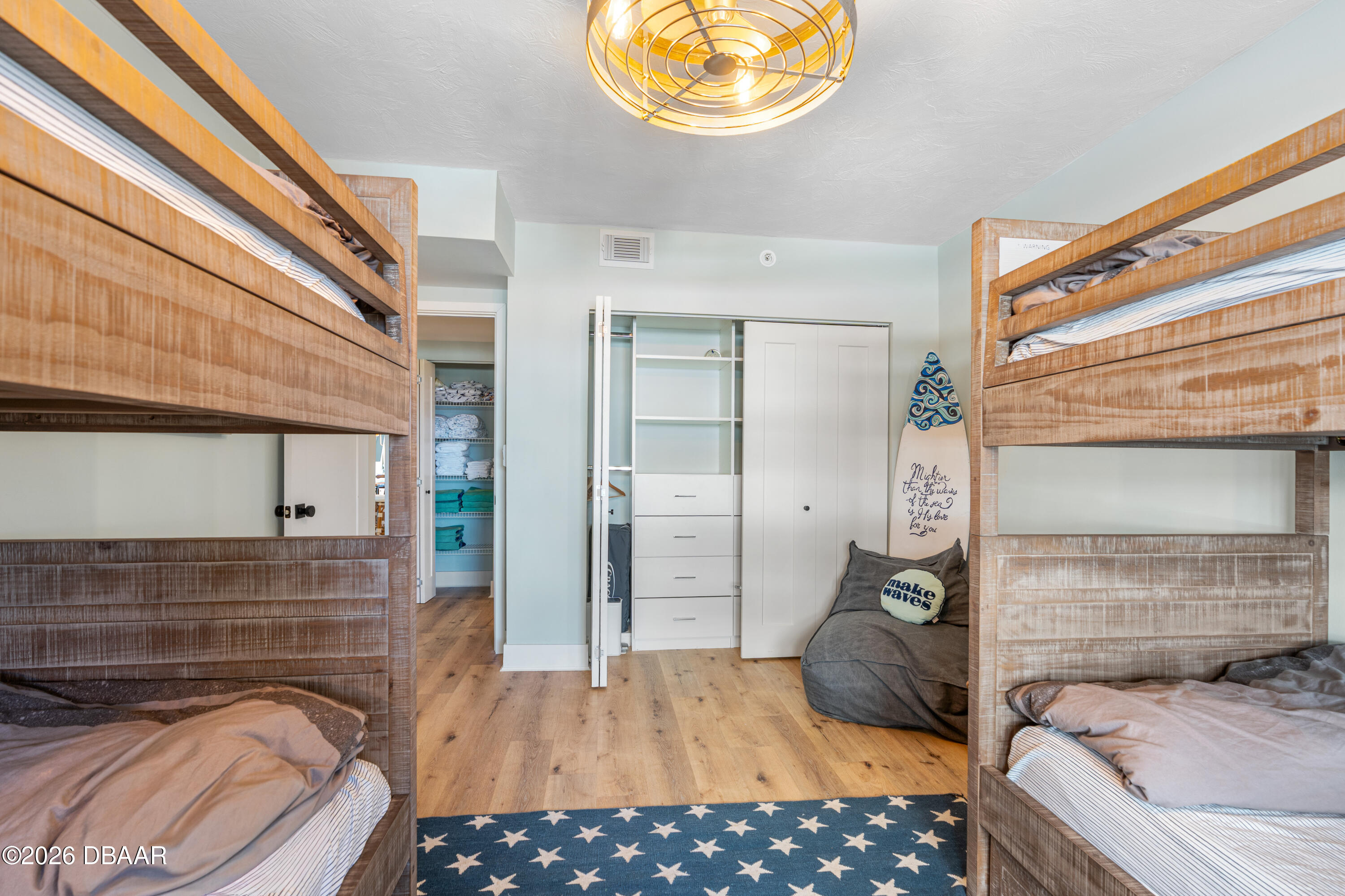 4565 South Atlantic Avenue, Unit 5410 Ponce Inlet, FL 32127 - Photo 46 of 67 a bedroom with a bed and a chandelier
