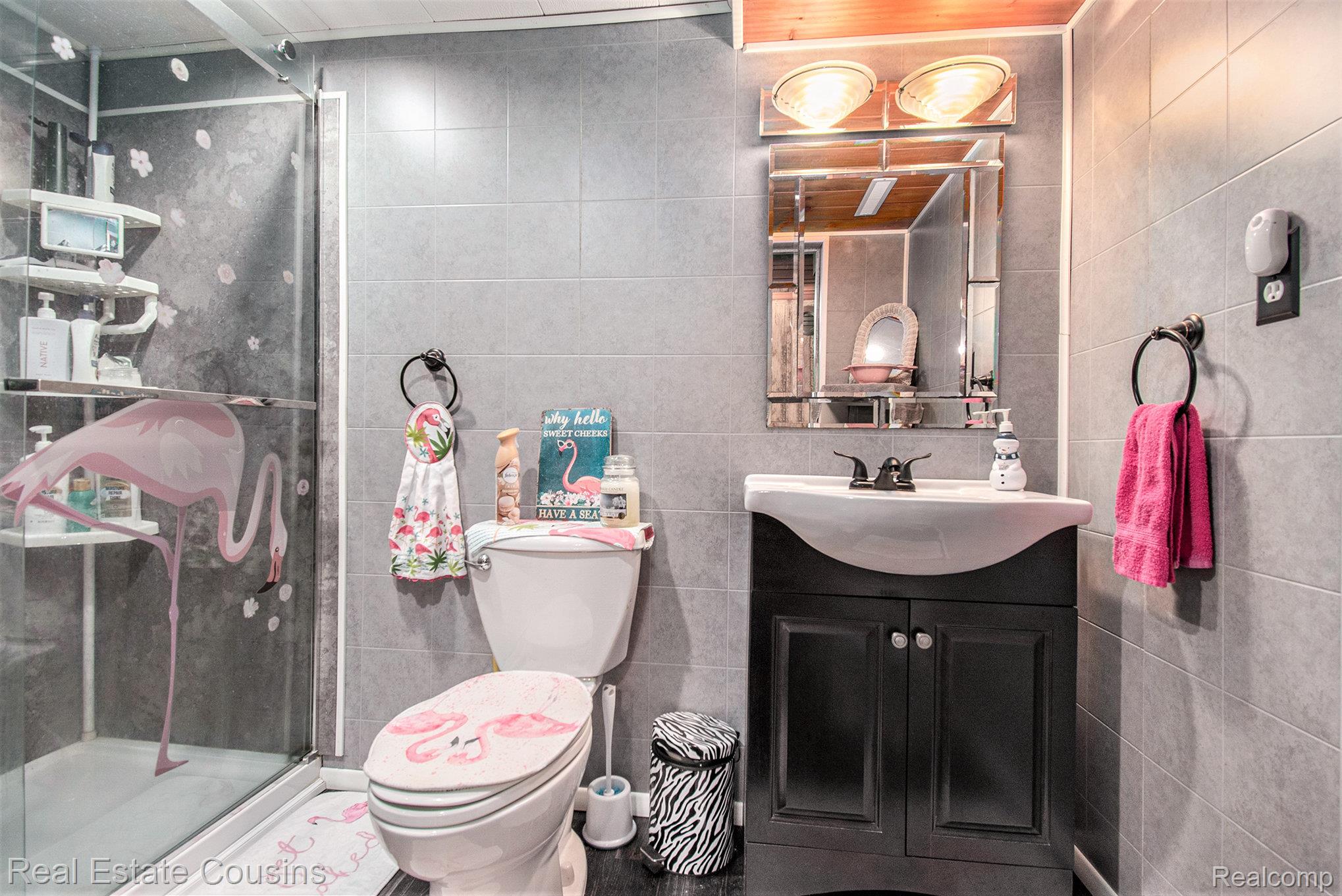 1734 Forest Road Harrison, MI 48625 - Photo 15 of 31 Bathroom with tile walls, vanity, and a stall shower