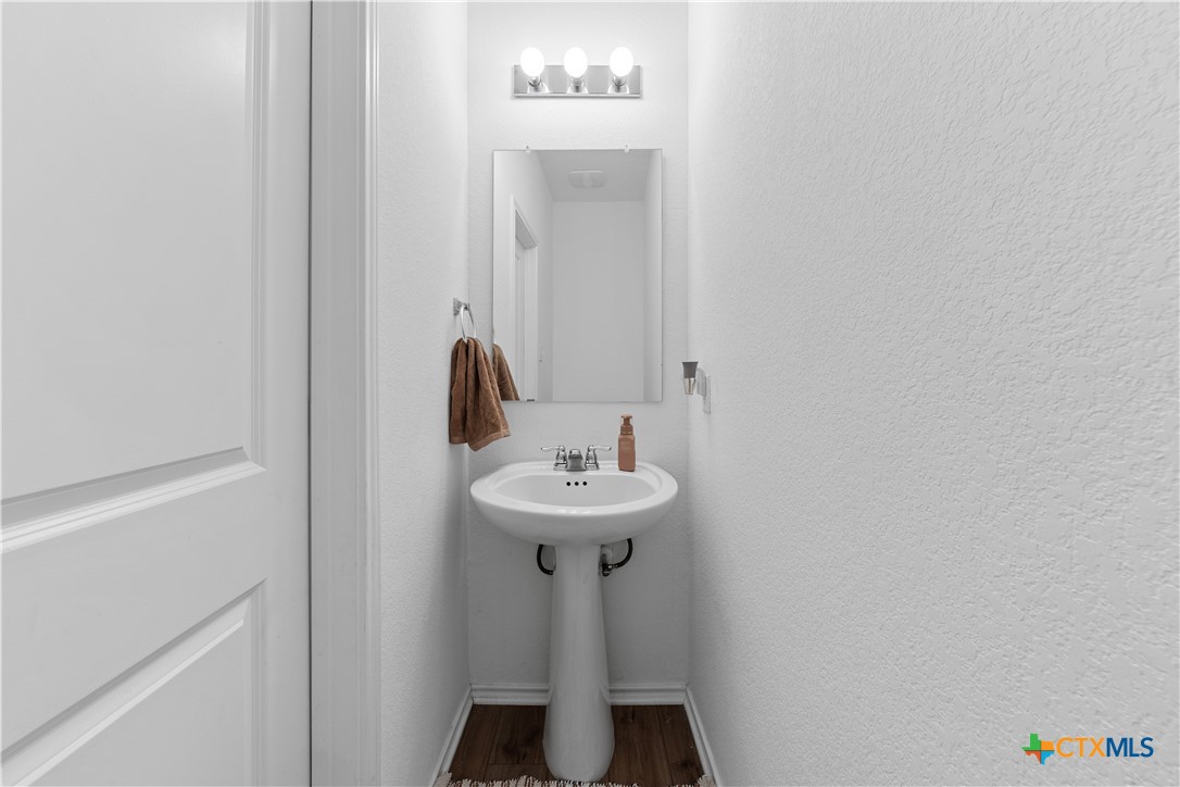 129 Rowdy Yates Way Jarrell, TX 76537 - Photo 12 of 41 a bathroom with a sink and a mirror