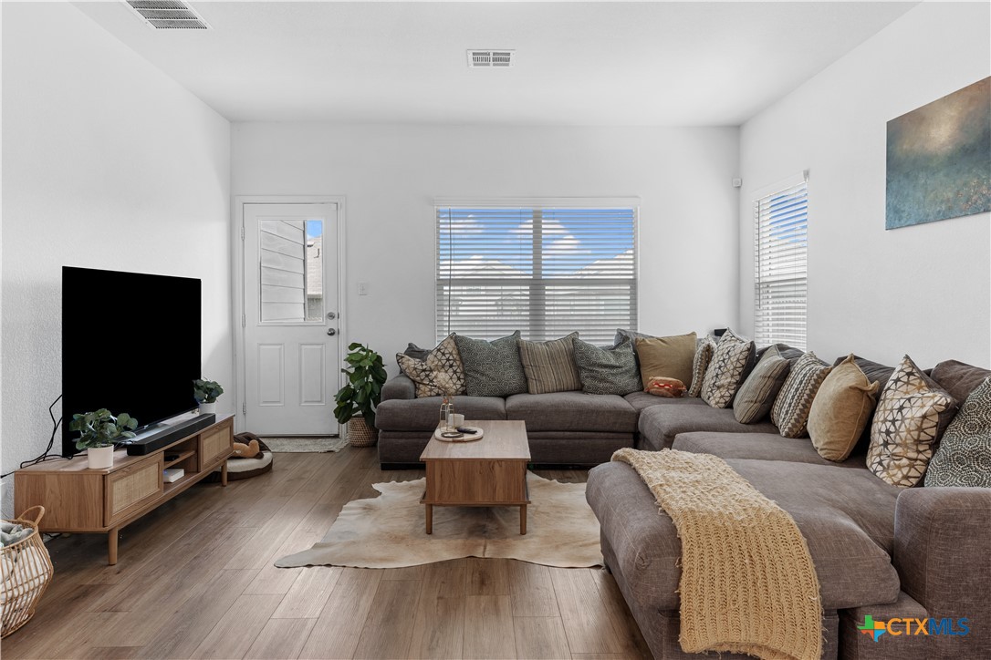 129 Rowdy Yates Way Jarrell, TX 76537 - Photo 16 of 41 a living room with furniture and a flat screen tv