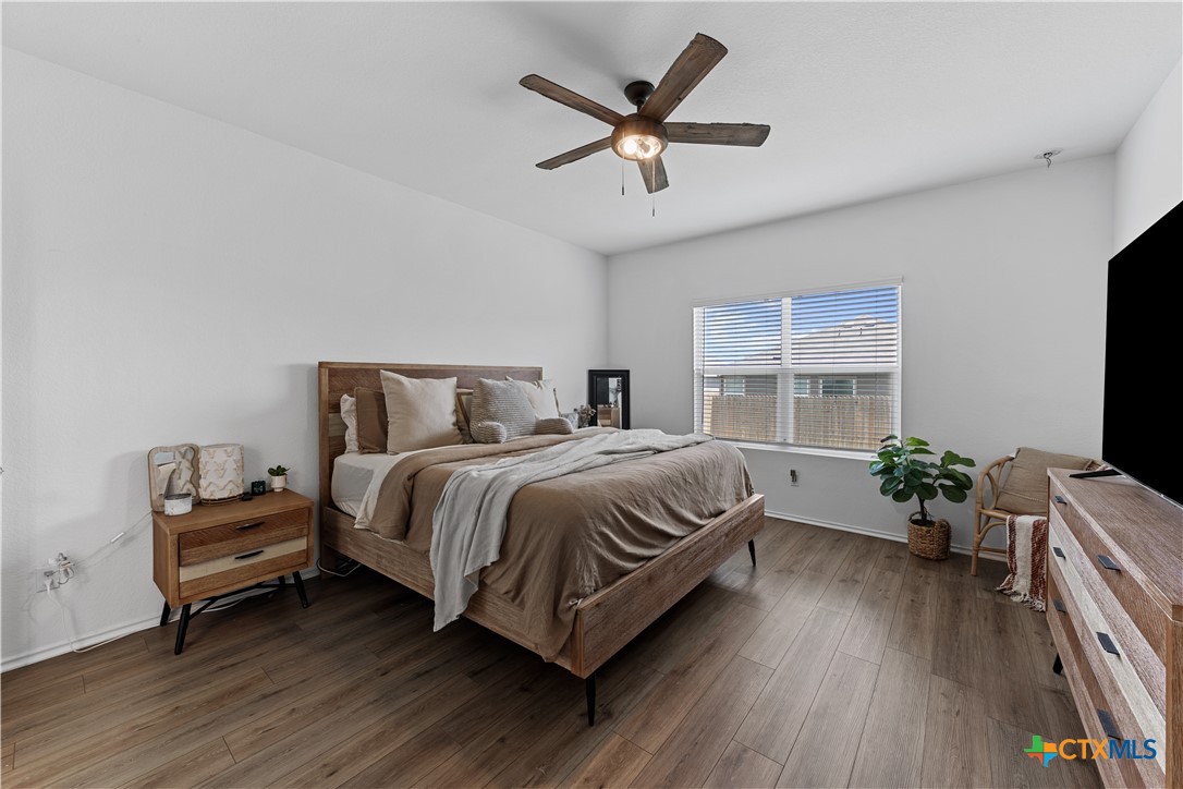 129 Rowdy Yates Way Jarrell, TX 76537 - Photo 17 of 41 a spacious bedroom with a bed and a flat screen tv