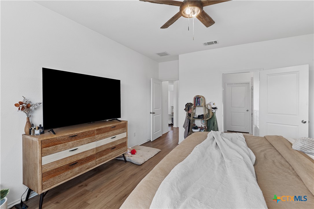 129 Rowdy Yates Way Jarrell, TX 76537 - Photo 18 of 41 a bedroom with a bed and a flat screen tv