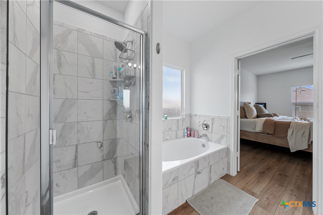 129 Rowdy Yates Way Jarrell, TX 76537 - Photo 20 of 41 a bathroom with a bathtub and a sink