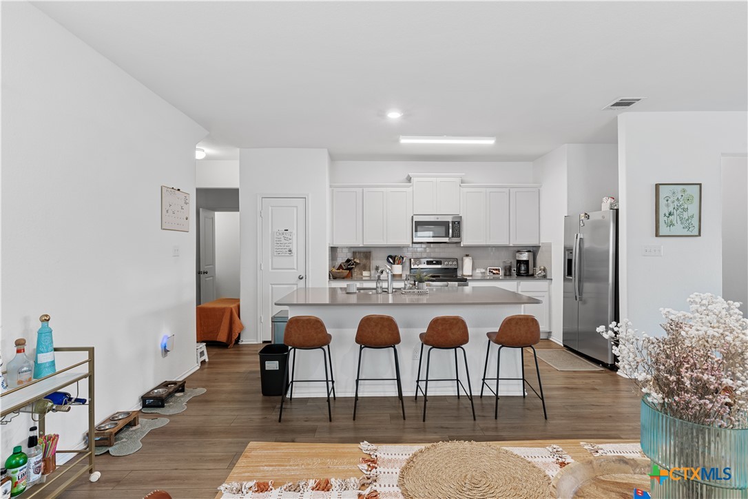 129 Rowdy Yates Way Jarrell, TX 76537 - Photo 22 of 41 a living room with stainless steel appliances granite countertop furniture rug and wooden floor