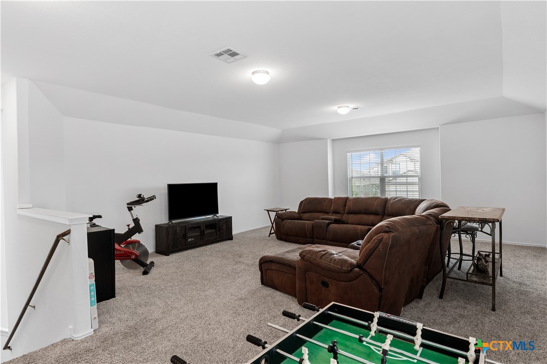 129 Rowdy Yates Way Jarrell, TX 76537 - Photo 25 of 41 a living room with furniture and a flat screen tv
