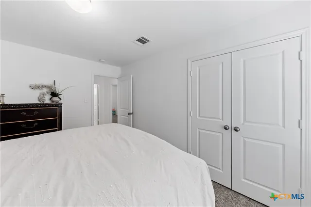 a bedroom with a bed and a cabinets