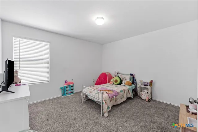 a bedroom with furniture and a window