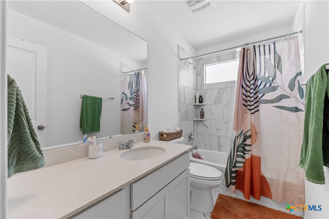 129 Rowdy Yates Way Jarrell, TX 76537 - Photo 34 of 41 a bathroom with a sink a toilet and shower