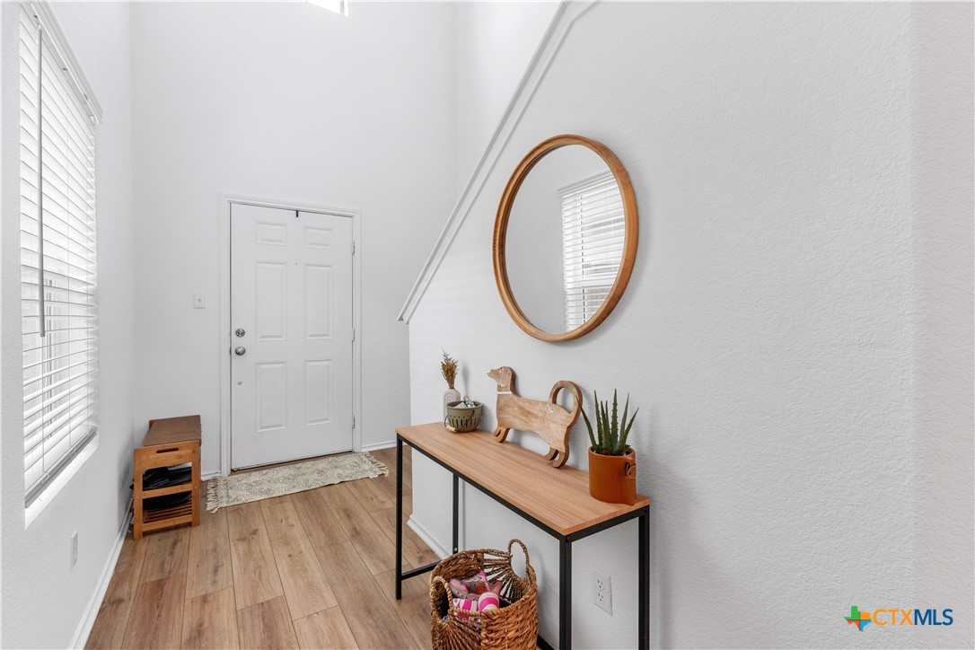 129 Rowdy Yates Way Jarrell, TX 76537 - Photo 4 of 41 wooden floor with a table and a chair