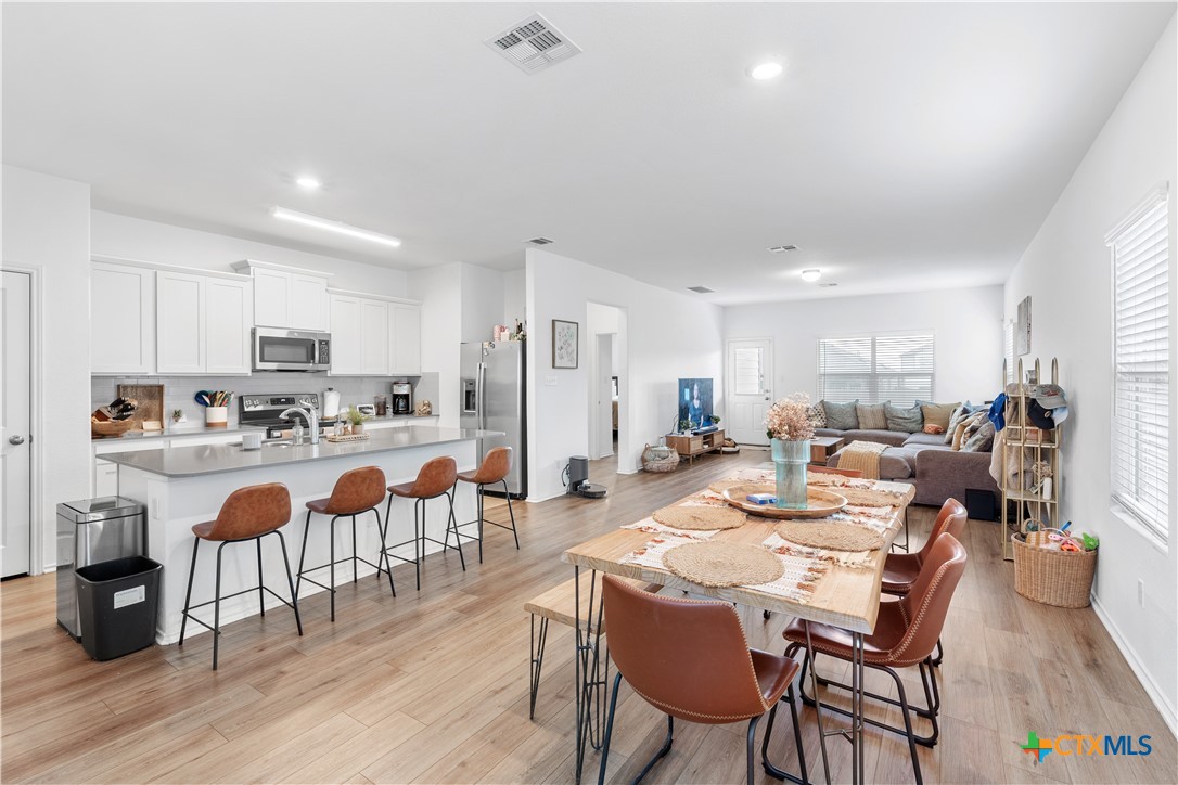 129 Rowdy Yates Way Jarrell, TX 76537 - Photo 5 of 41 a large kitchen with a table and chairs