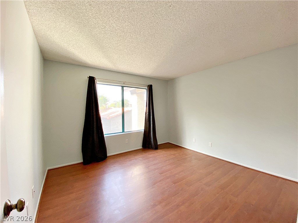 1575 West Warm Springs Road, Unit 1024 Henderson, NV 89014 - Photo 9 of 25 Rich hardwood floors complement the natural light entering this adaptable room.