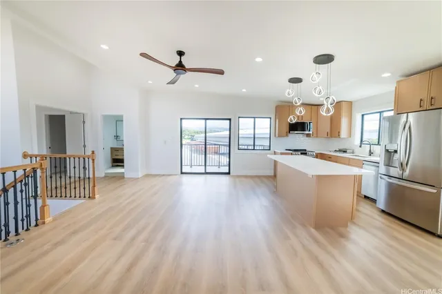 a large kitchen with a lot of counter space and stainless steel appliances