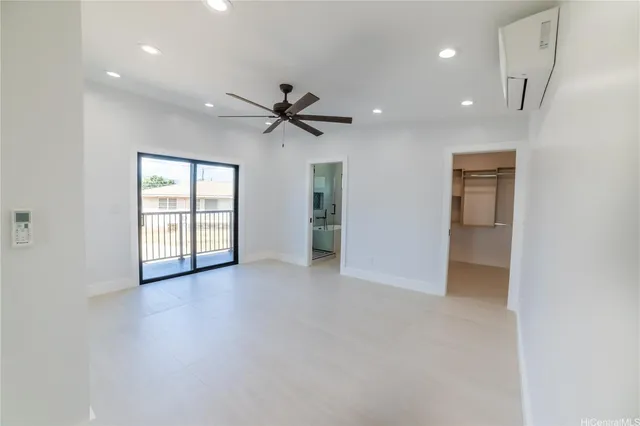 an empty room with windows and cabinet
