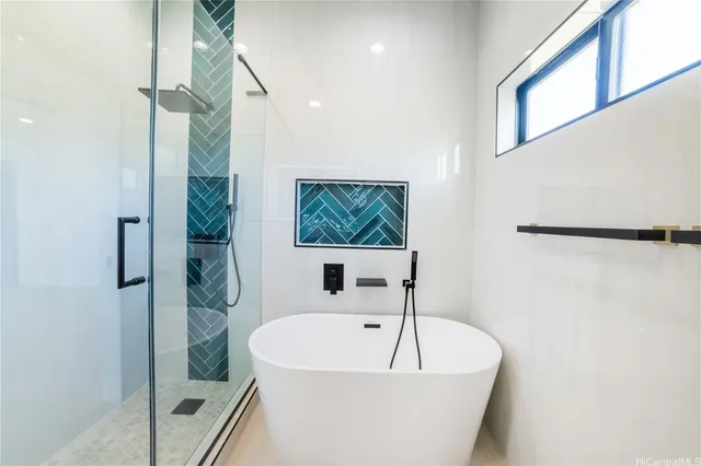a bathroom with a bathtub and a shower