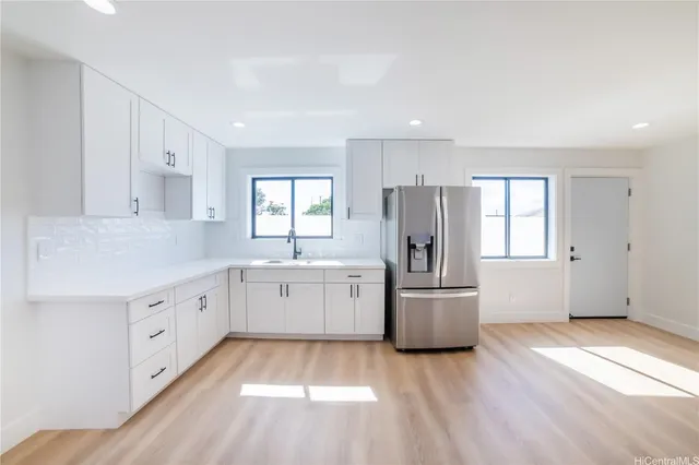 a kitchen with a refrigerator and a sink