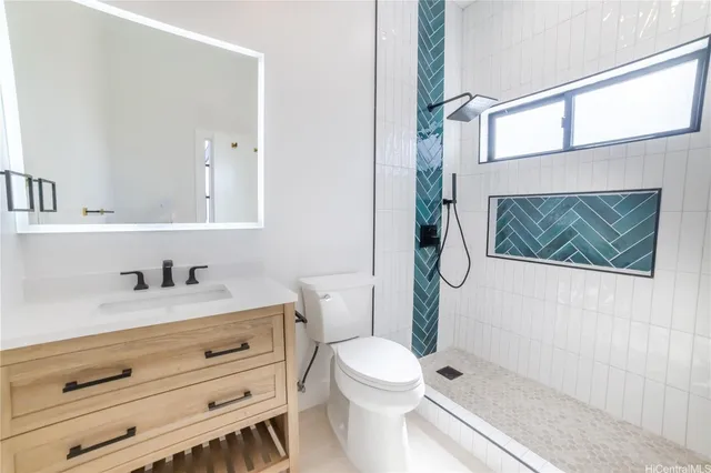 a bathroom with a granite countertop toilet sink and mirror