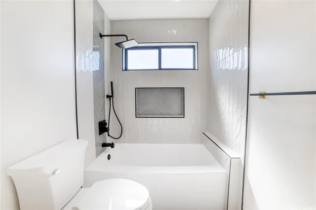 a bathroom with a toilet a sink and a bathtub