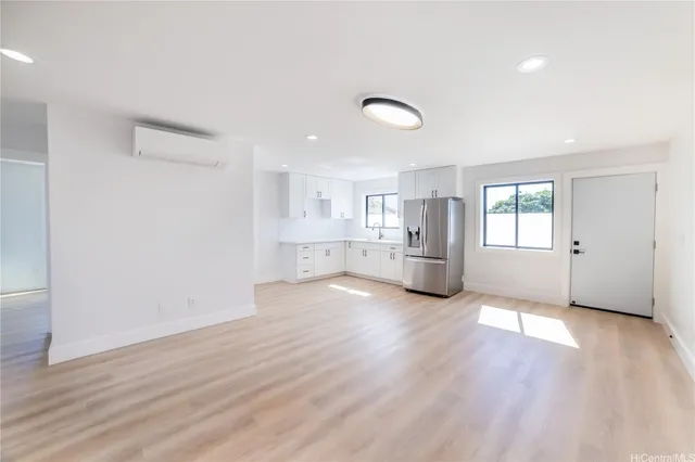 a view of a kitchen with wooden floor and windows