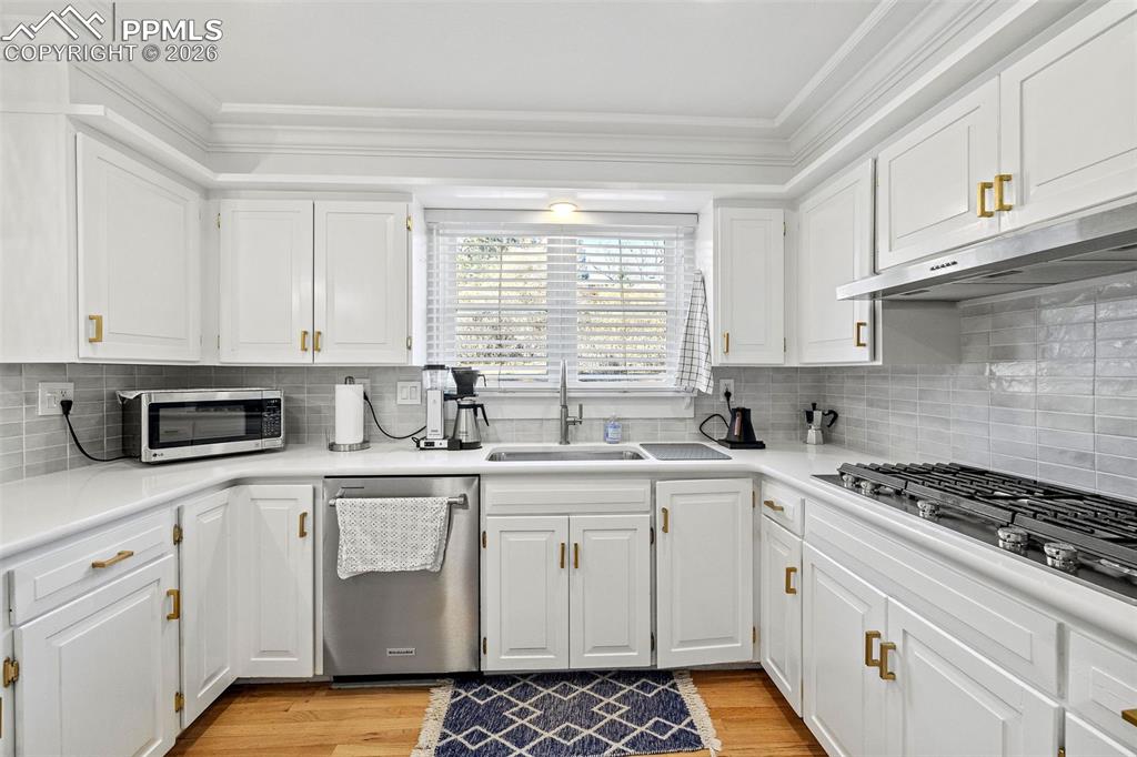 2 Cresta Road Colorado Springs, CO 80906 - Photo 11 of 33 a kitchen with stainless steel appliances white cabinets granite counter tops and a window