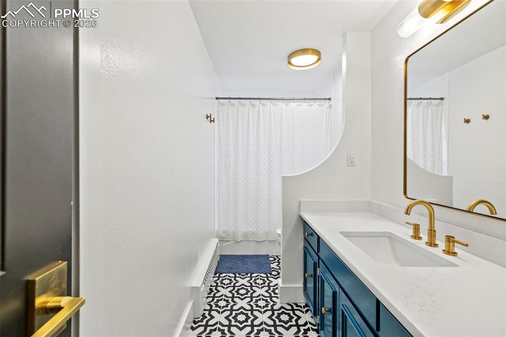 2 Cresta Road Colorado Springs, CO 80906 - Photo 14 of 33 a bathroom with a sink and a mirror